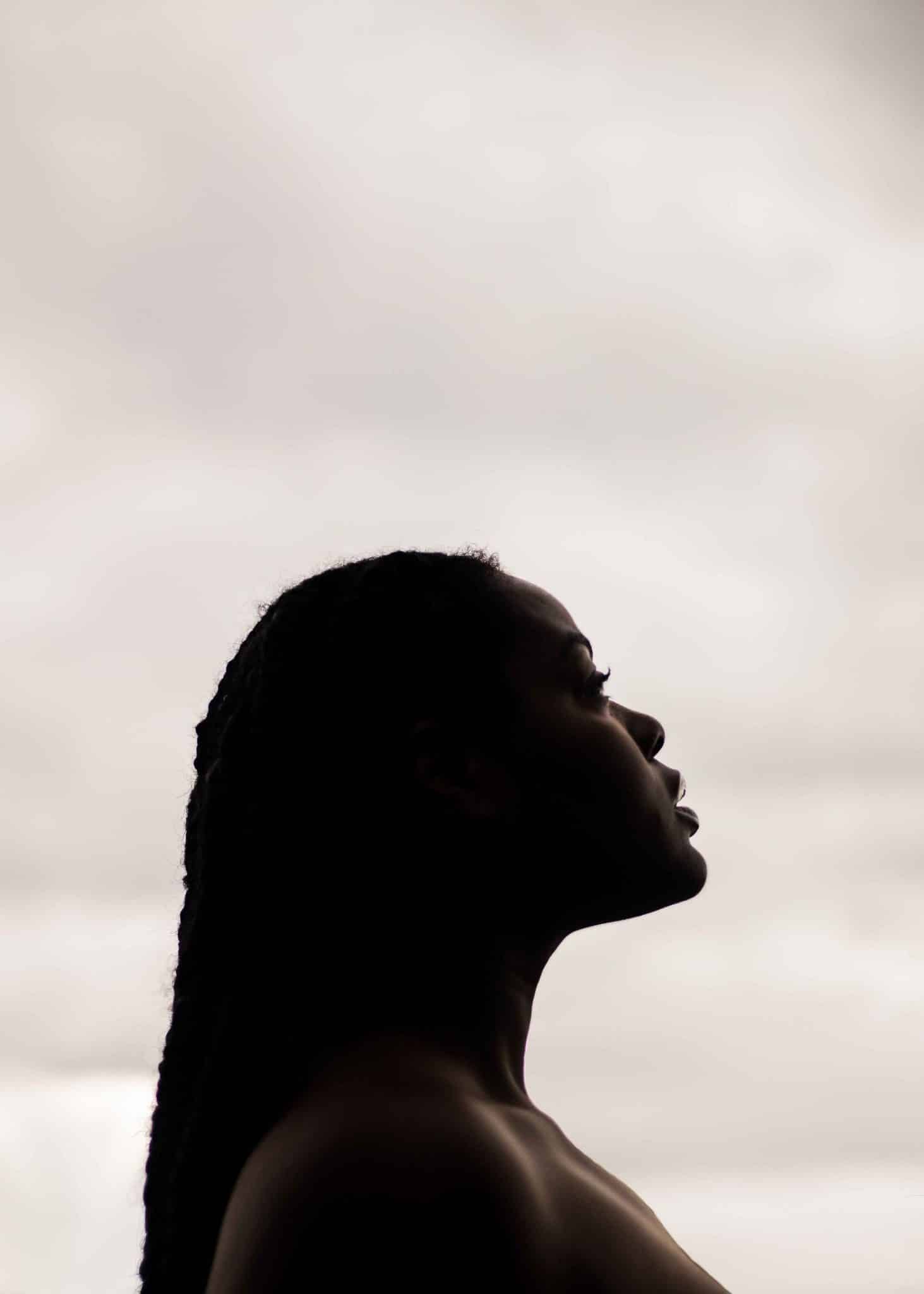 Black woman looking to the sky, choosing comfort vs happiness